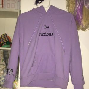Cute, soft lavender purple hoodie “Be Curious” cat designs on sleeves